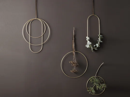 Die goldenen Messingringe von ferm Living in der Ambienteansicht: Die Frames sorgen an der Wand oder über der Fensterbank für festliche Stimmung und können mit Zweigen oder Ästen umwickelt werden.