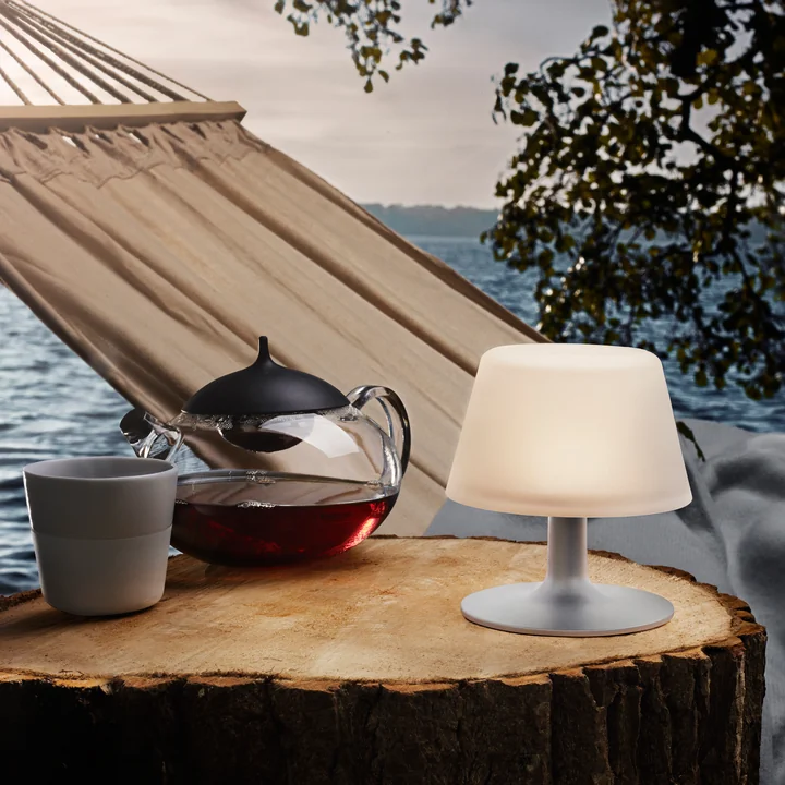 Die SunLight Tischleuchte von Eva Solo im Freien vor einer Hängematte Die SunLight Tischleuchte von Eva Solo im Freien vor einer Hängematte