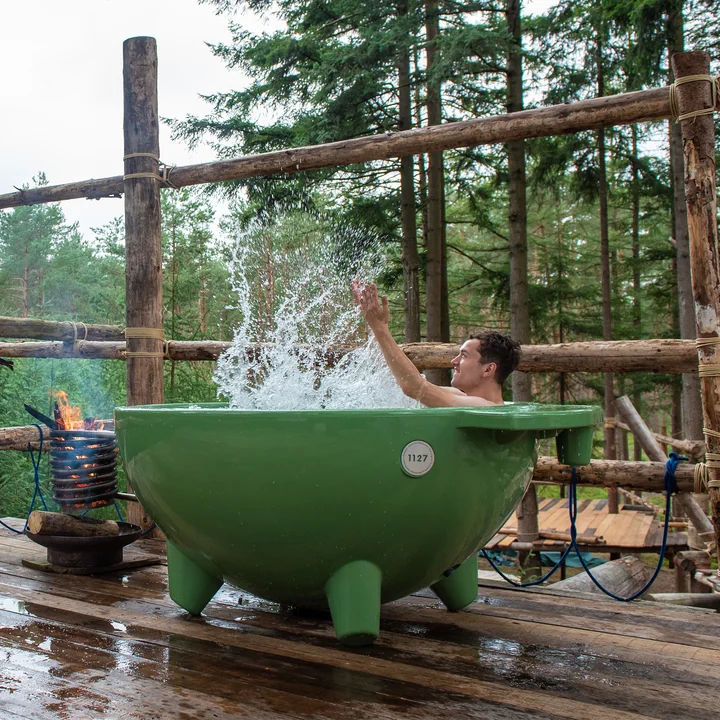 Die Dutchtub Original von Weltevree auf einer hohen Holz-Plattform mitten im Wald